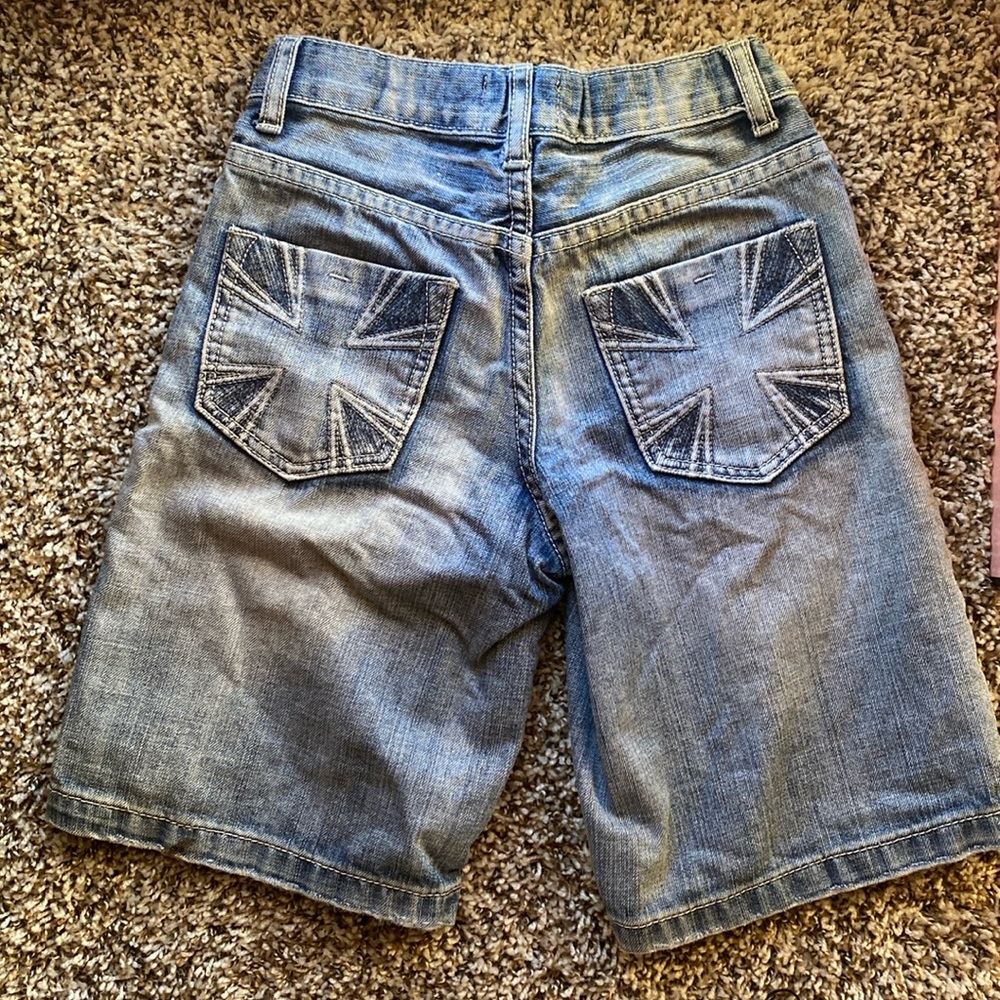 washed blue jeans cross design on back pockets